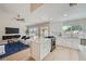 Open-concept kitchen featuring white cabinets, an island, stainless steel appliances, and seamless flow to the living room at 3012 Haddon Dr, Las Vegas, NV 89134