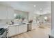 Bright kitchen features white cabinets, stainless appliances, and a view of the outdoor living area through large windows at 3012 Haddon Dr, Las Vegas, NV 89134
