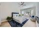 Cozy bedroom featuring a large bed, accent chair and natural light from bay window at 3012 Haddon Dr, Las Vegas, NV 89134
