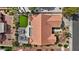 Aerial view of a landscaped backyard featuring a lawn, patio, and mature desert landscaping at 3024 Lotus Hill Dr, Las Vegas, NV 89134