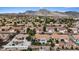 Aerial view of community showcasing homes with backyard patios, trees and mountain views at 3024 Lotus Hill Dr, Las Vegas, NV 89134