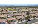 Aerial view of a Las Vegas neighborhood with mature landscaping, tile roofs, and a green golf course at 3024 Lotus Hill Dr, Las Vegas, NV 89134