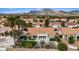 Backyard featuring a well-manicured lawn, mature landscaping, and a covered patio with furnishings at 3024 Lotus Hill Dr, Las Vegas, NV 89134
