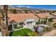 Backyard featuring a well-manicured lawn, mature landscaping, and a covered patio with furnishings at 3024 Lotus Hill Dr, Las Vegas, NV 89134