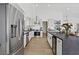 Modern kitchen with stainless steel appliances, white cabinets, and ample counter space at 3024 Lotus Hill Dr, Las Vegas, NV 89134