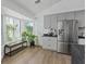 Bright kitchen nook with a bay window, stainless steel refrigerator, and modern cabinets at 3024 Lotus Hill Dr, Las Vegas, NV 89134