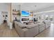Spacious living room with a modern fireplace, large sectional, and beautiful shelving at 3024 Lotus Hill Dr, Las Vegas, NV 89134