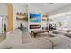 Comfortable living room with a modern fireplace, mounted TV, and built-in shelving with decorative items at 3024 Lotus Hill Dr, Las Vegas, NV 89134