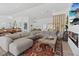 Bright living room with modern decor, a fireplace, and an open view to the kitchen and dining area at 3024 Lotus Hill Dr, Las Vegas, NV 89134