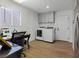 Bright home office with a window, laundry machines, and hardwood flooring at 3024 Lotus Hill Dr, Las Vegas, NV 89134
