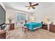 Relaxing bedroom featuring a ceiling fan, plantation shutters, and tile flooring at 3056 Monroe Park Rd, Henderson, NV 89052