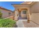 Inviting covered front porch and walkway leading to the entrance of the home with mature landscaping at 3056 Monroe Park Rd, Henderson, NV 89052