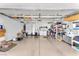 Spacious garage featuring epoxy floor, overhead storage, and ample lighting at 3056 Monroe Park Rd, Henderson, NV 89052