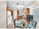 Bright eat-in kitchen with stainless appliances, wood cabinets, and a glass-top dining table at 3056 Monroe Park Rd, Henderson, NV 89052