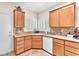 Well-lit kitchen boasts stone countertops, wood cabinetry, stainless steel sink, and white plantation shutters at 3056 Monroe Park Rd, Henderson, NV 89052