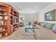Inviting living room boasts tile flooring, neutral paint, and custom built-in shelving at 3056 Monroe Park Rd, Henderson, NV 89052