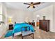 Bright main bedroom featuring tile flooring, a ceiling fan, and private ensuite access at 3056 Monroe Park Rd, Henderson, NV 89052