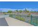 Expansive balcony with wrought iron railing offering panoramic views of the surrounding desert landscape and clear blue sky at 3079 Evening Mist Ave, Henderson, NV 89052