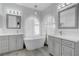 Bright bathroom boasts double vanities with a free-standing soaking tub and elegant fixtures at 3079 Evening Mist Ave, Henderson, NV 89052