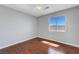 Sunlit bedroom with hardwood flooring, ceiling fan, and a view of the mountains at 3079 Evening Mist Ave, Henderson, NV 89052