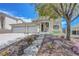 Two-story home with a three-car garage with desert landscaping at 3079 Evening Mist Ave, Henderson, NV 89052
