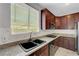 Traditional-style kitchen with cherry wood cabinetry, granite countertops and stainless steel appliances at 3079 Evening Mist Ave, Henderson, NV 89052