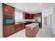 Charming kitchen with stainless steel appliances, marble floors, wooden cabinets, and a center island at 3079 Evening Mist Ave, Henderson, NV 89052