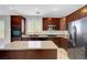 Gourmet kitchen features a center island, stainless steel appliances, and dark wood cabinets at 3079 Evening Mist Ave, Henderson, NV 89052