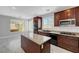 Kitchen with wooden cabinets, an island, stainless steel appliances, and marble flooring at 3079 Evening Mist Ave, Henderson, NV 89052