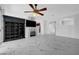 Stylish living room with a fireplace, built-in shelving, backyard access, and marble flooring at 3079 Evening Mist Ave, Henderson, NV 89052