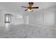 Light-filled living room featuring marble flooring, a ceiling fan, and decorative wall cut-outs at 3079 Evening Mist Ave, Henderson, NV 89052
