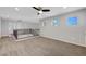 Bright, airy loft featuring neutral color carpet, ample natural light and well-appointed black metal and wood railing at 3079 Evening Mist Ave, Henderson, NV 89052