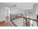 Spacious upper-level loft with decorative wood and metal railing offering serene views of the staircase and entry at 3079 Evening Mist Ave, Henderson, NV 89052