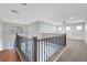 Upstairs loft featuring carpet, custom window lighting and well-appointed black metal and wood railing at 3079 Evening Mist Ave, Henderson, NV 89052