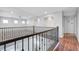 Bright, airy loft features sleek railings, archways, and a seamless blend of carpet and hardwood flooring at 3079 Evening Mist Ave, Henderson, NV 89052