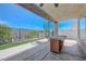 Outdoor kitchen with tiled counter, spiral staircase leading to upper balcony, and a low-maintenance yard at 3079 Evening Mist Ave, Henderson, NV 89052