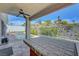 Covered outdoor kitchen with bar area, ceiling fan, and views of the lushly landscaped backyard with pool and spa at 3079 Evening Mist Ave, Henderson, NV 89052