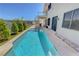 Sparkling pool stretches along the house offering an inviting oasis and a stylish balcony and spiral staircase at 3079 Evening Mist Ave, Henderson, NV 89052