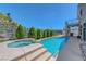 Beautiful pool and hot tub combo with a serene hillside view, perfect for relaxing or entertaining at 3079 Evening Mist Ave, Henderson, NV 89052