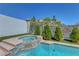 Refreshing pool and spa, framed by manicured greenery and a privacy wall, creating an idyllic backyard escape at 3079 Evening Mist Ave, Henderson, NV 89052