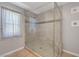 Modern bathroom shower with frameless glass door and tiled walls, a clean and bright design at 3079 Evening Mist Ave, Henderson, NV 89052