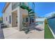 Rear exterior featuring a spiral staircase leading to an upper-level balcony overlooking the pool and backyard area at 3079 Evening Mist Ave, Henderson, NV 89052