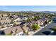Elevated street view showcasing a community of homes, lush greenery, and distant mountains at 3079 Paseo Mountain Ave, Henderson, NV 89052