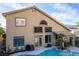 The backyard features a sparkling pool, covered patio, and a lush, well-maintained lawn at 3079 Paseo Mountain Ave, Henderson, NV 89052