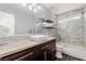 Updated bathroom featuring dark cabinets, modern fixtures and marble-look tile at 3079 Paseo Mountain Ave, Henderson, NV 89052