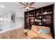 This inviting bonus space is enhanced by custom built-ins, a ceiling fan and wood-look floors at 3079 Paseo Mountain Ave, Henderson, NV 89052