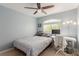 Comfortable bedroom with a ceiling fan, large window, and desk space at 3079 Paseo Mountain Ave, Henderson, NV 89052