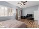 Cozy bedroom highlighting wood floors, patio access, and a large window at 3079 Paseo Mountain Ave, Henderson, NV 89052