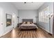 Bright bedroom featuring wood floors, large windows, and stylish lighting at 3079 Paseo Mountain Ave, Henderson, NV 89052