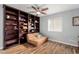 This bonus bedroom offers wood-look floors, ceiling fan and custom built-in shelving at 3079 Paseo Mountain Ave, Henderson, NV 89052